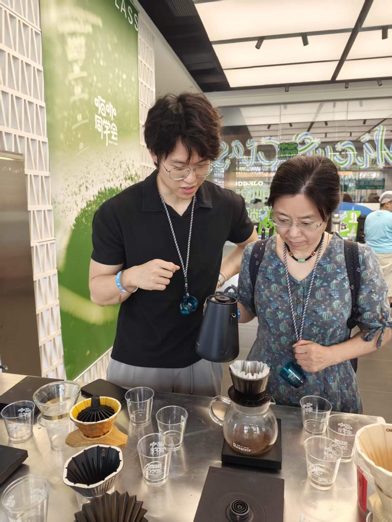 My mom holding a dripper during the workshop
